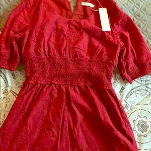 Red (Jessica Robertson) knee length dress.